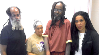 A visibly ill Mumia Abu-Jamal is surrounded by Abdu Jon, Pam Africa and Johanna Fernandez.Courtesy of the Campaign to Bring Mumia Home